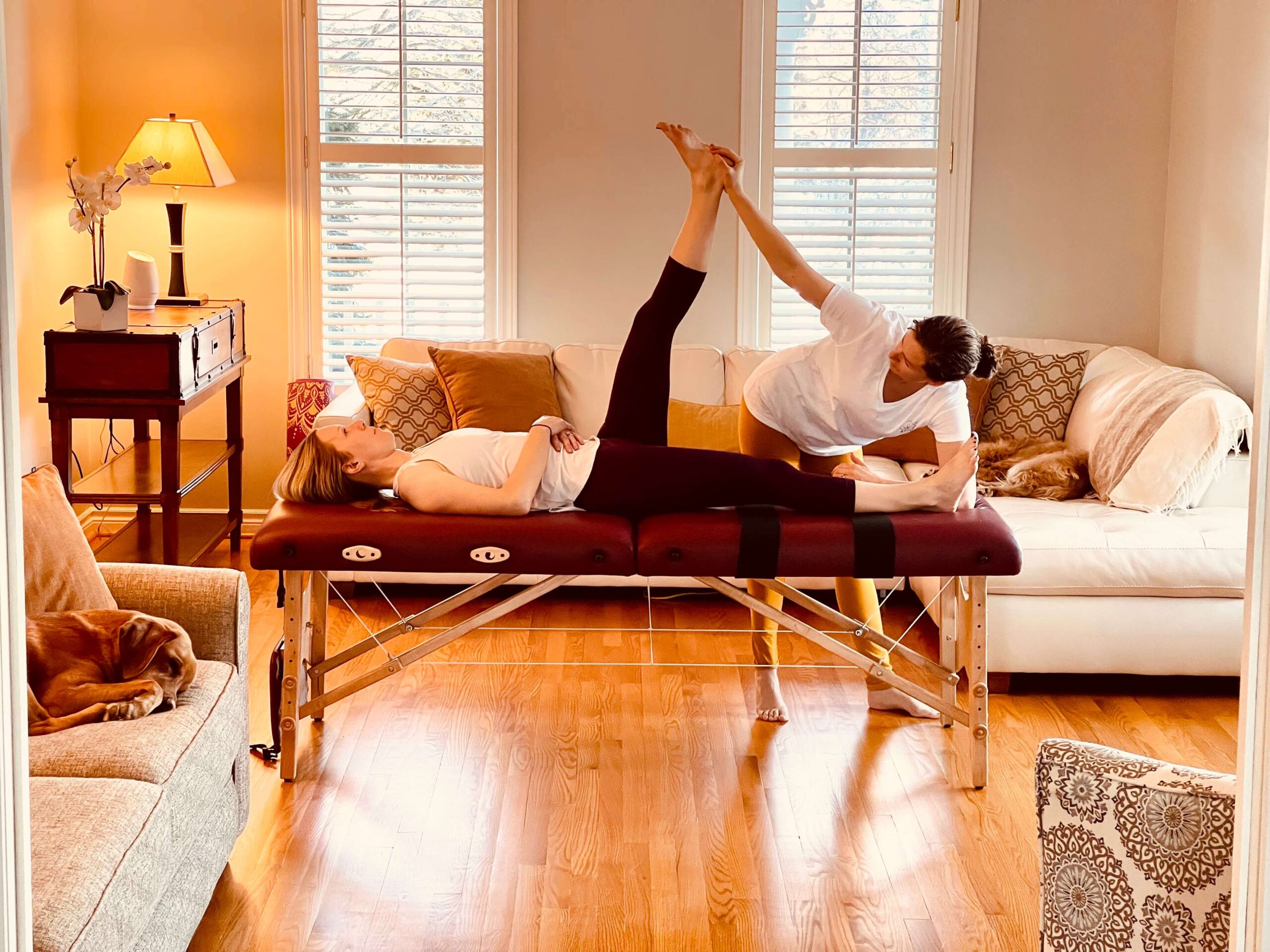 Fascial stretch therapy on leg in living room
