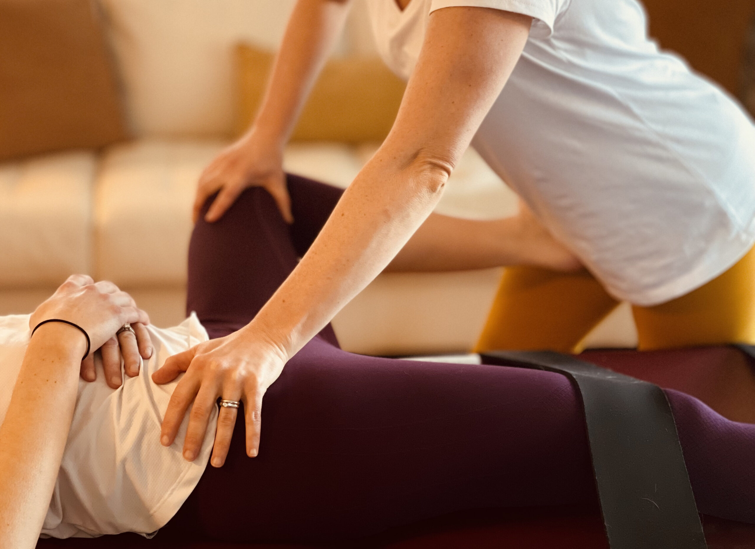 Fascial stretch therapy on leg in living room